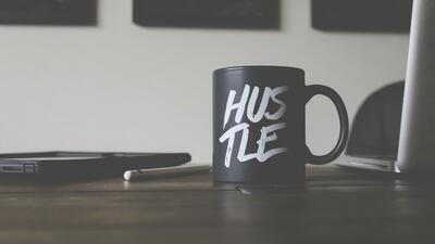 Hustle mug on desk